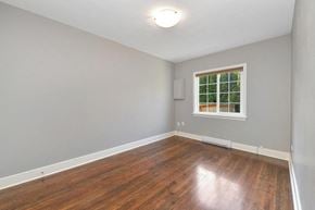 Victoria apartment for rent - an empty living room with wood floors and a window