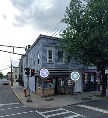 Plainfield apartment for rent - a gray building on the corner of a city street