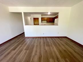 Shepherdsville apartment for rent - the living room of an empty apartment with wood flooring and white walls