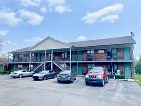 Shepherdsville apartment for rent - the front of a motel with cars parked in front of it