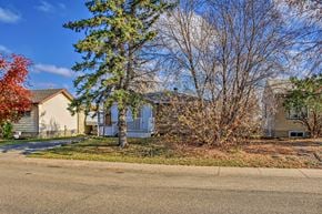 Edmonton house for rent - the front yard of a house with trees and a street