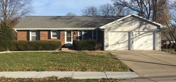 Kansas City house for rent - A house with a white garage door and a brick facade.