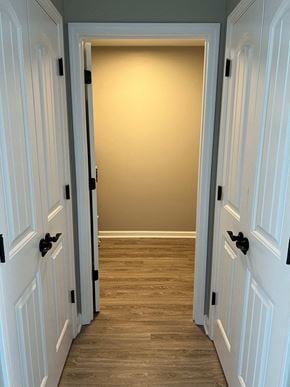 Shelbyville apartment for rent - a hallway with a wood floor and white doors
