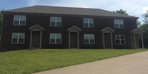 Shelbyville apartment for rent - a house with a sidewalk and grass in front of it