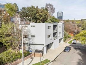 Los Angeles apartment for rent - A modern apartment building with a car parked in front.