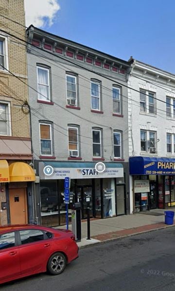 Perth Amboy apartment for rent - a red car parked in front of a building on a street