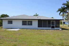 Cape Coral house for rent - the front of the house with palm trees in the background