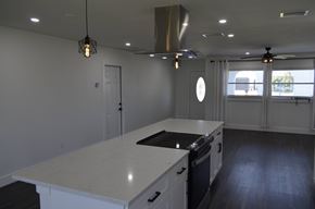 Cape Coral house for rent - a kitchen with an island and a stove and a window