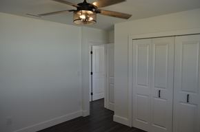 Cape Coral house for rent - a bedroom with two closets and a ceiling fan