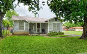 San Antonio house for rent - a small green house with a yard and a tree