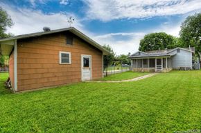 San Antonio house for rent - a backyard with a house and a yard with grass