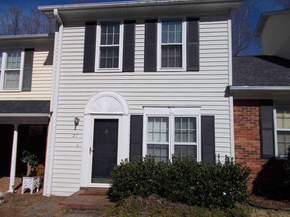 Spartanburg house for rent - a white house with black shutters and a black door