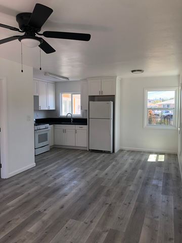 San Diego apartment for rent - A kitchen with a fan and wooden floors.