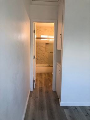 San Diego apartment for rent - A hallway with a doorway leading to another room.