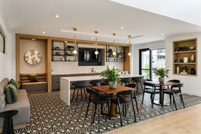 Sacramento apartment for rent - A modern dining room with a patterned floor and a wooden table surrounded by chairs.