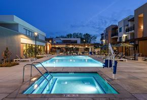 Sacramento apartment for rent - A large outdoor swimming pool with a diving board and a slide.
