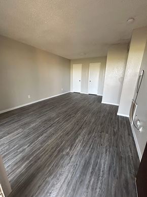 Rosebud apartment for rent - A room with wood flooring and white walls.