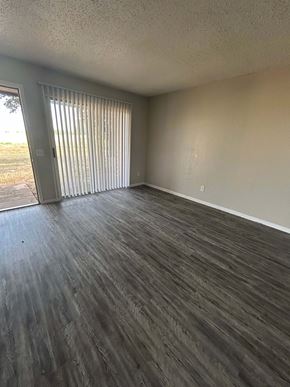 Rosebud apartment for rent - A room with a sliding door and wood flooring.