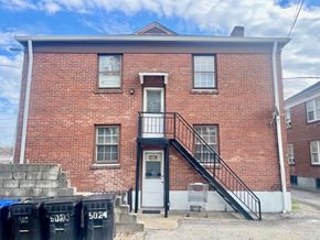 Louisville apartment for rent - A red brick building with a black metal staircase.