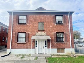 Louisville apartment for rent - A red brick building with a white door and windows.