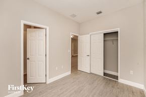 Palm Bay house for rent - a bedroom with two closets and a door to a hallway