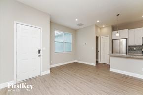 Palm Bay house for rent - a kitchen and living room with a refrigerator and a door