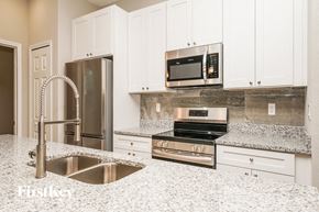 Palm Bay house for rent - a white kitchen with granite counter tops and stainless steel appliances