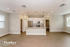 Palm Bay house for rent - an empty living room with a kitchen with a counter top