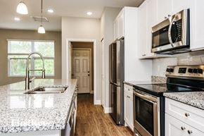 Palm Bay house for rent - a kitchen with granite counter tops and stainless steel appliances