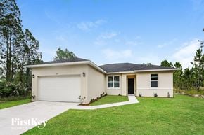 Palm Bay house for rent - a white house with a lawn and a garage door