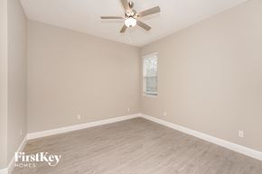 Palm Bay house for rent - the spacious living room with a ceiling fan and wood flooring