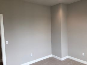 Bridgeville apartment for rent - a corner of a room with grey walls and white carpet