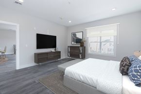 Hackensack apartment for rent - a bedroom with a large bed and a tv