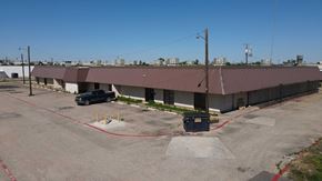 Garland apartment for rent - a building with a parking lot and a car parked in front of it