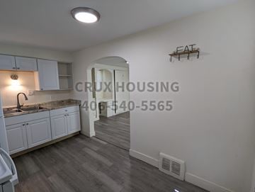 Great Falls apartment for rent - A kitchen with a sink and a counter with a light on.