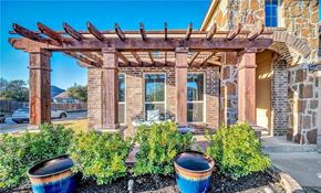 Killeen house for rent - the front yard of a brick house with potted plants