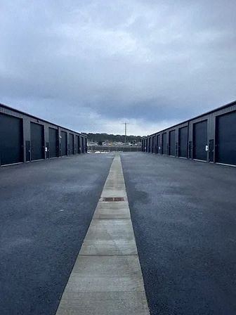 Post Falls apartment for rent - an empty parking lot with rows of garages