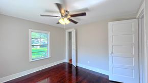 Bay City house for rent - an empty living room with a ceiling fan and a window