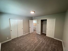 Fort Collins apartment for rent - a bedroom with two closets and a carpeted floor