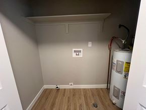 Fort Collins apartment for rent - a room with a water heater and a wall with a dryer