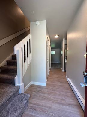 Fort Collins apartment for rent - a look down the hallway of a house with stairs and a hallway with carpeting