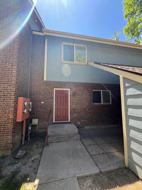 Fort Collins apartment for rent - the front of a brick house with a red door