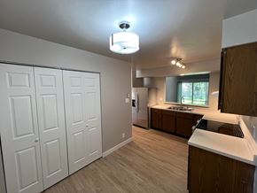 Fort Collins apartment for rent - a kitchen with white cabinets and a sink and a refrigerator