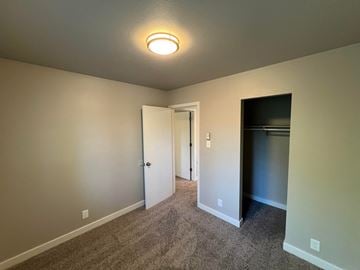 Fort Collins apartment for rent - a living room with carpet and a door to a closet