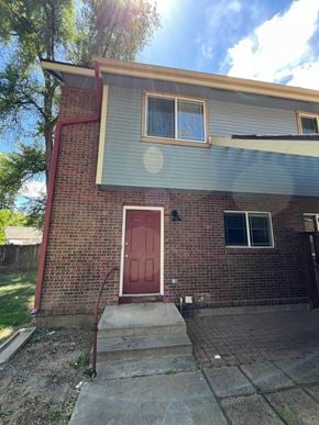 Fort Collins apartment for rent - the front of a brick house with a red door