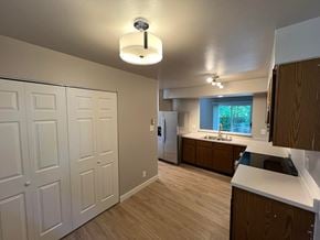 Fort Collins apartment for rent - a kitchen with white cabinets and wood floors and a white refrigerator