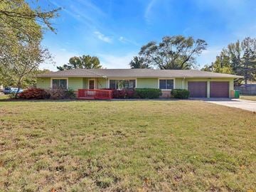 Wichita house for rent - the front of a house with a lawn and a red porch