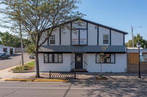 Monticello apartment for rent - a white building with a black and white awning on the corner of a