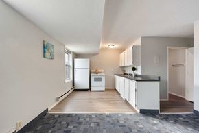 Monticello apartment for rent - a kitchen with white cabinets and a counter top and a refrigerator
