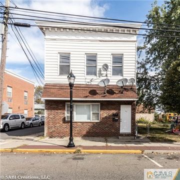 Carteret apartment for rent - a small brick building with satellites on it on a street